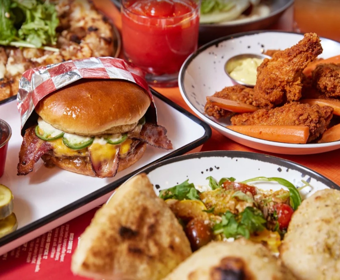 Shin Dig food spread with burger, wings and drinks